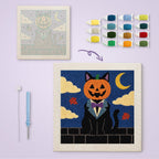 Pumpkin Head Cat canvas before and after punching, with the threads and tools