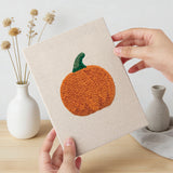Hand holding a finished Pumpkin Pepper Patch mini canvas