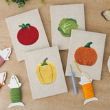 The four finished Pumpkin Pepper Patch mini canvases laid out on a table