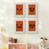 The four Pumpkin Scowls mini canvases on a wall above a shelf