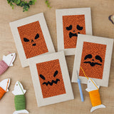 The four finished Pumpkin Scowls mini canvases laid out on a table