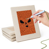 Hand punching one of the Pumpkin Scowls mini canvases