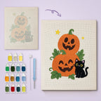Pumpkin Stack and Cat canvas before and after punching, with the threads and tools