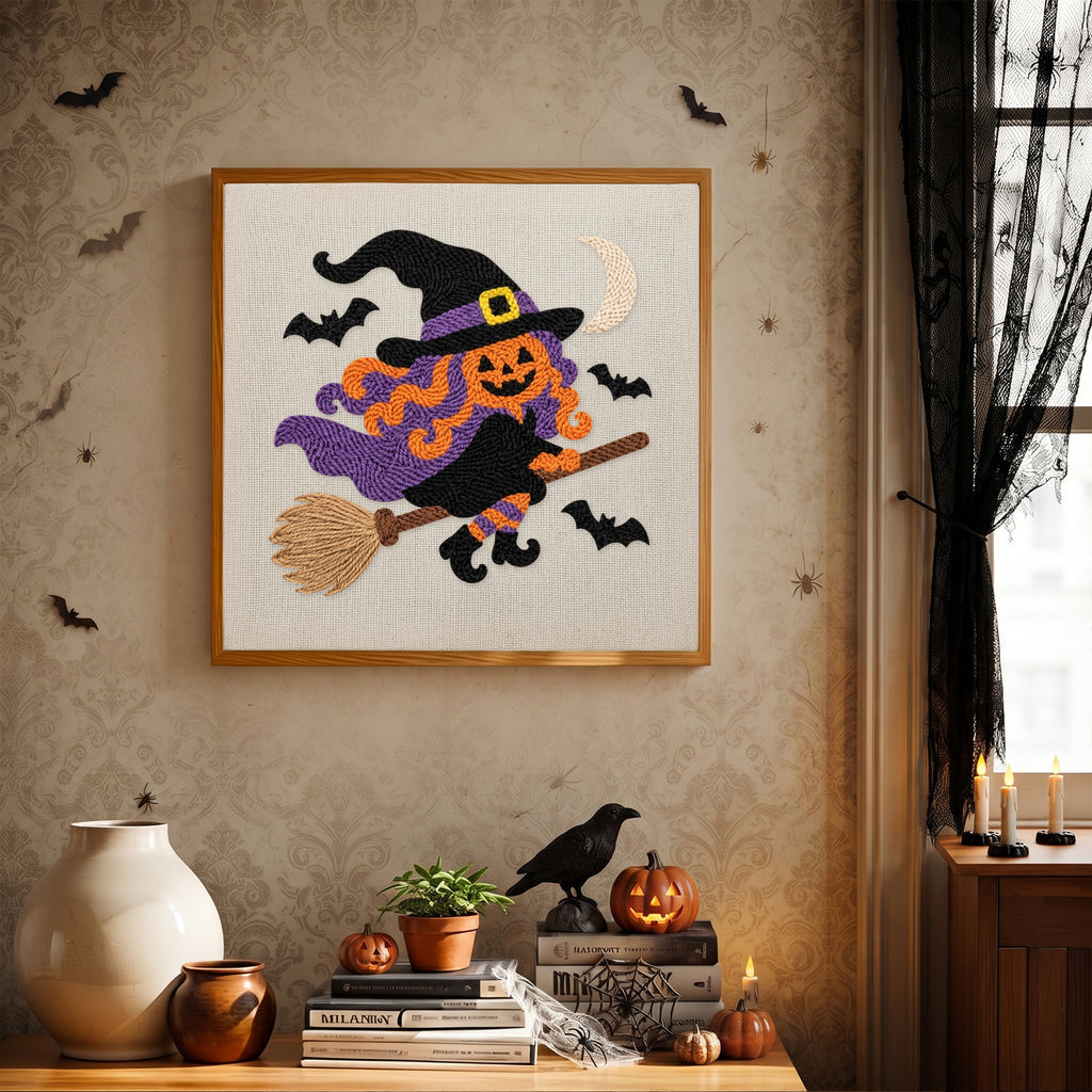 Finished Pumpkin Witch in Flight punch needle canvas on a wall