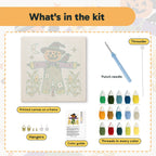 What is in the Purple Coat Scarecrow kit: printed canvas, punch needle, threader, threads, color guide and hangers