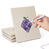 Hand punching one of the Purple Grape Bunch mini canvases
