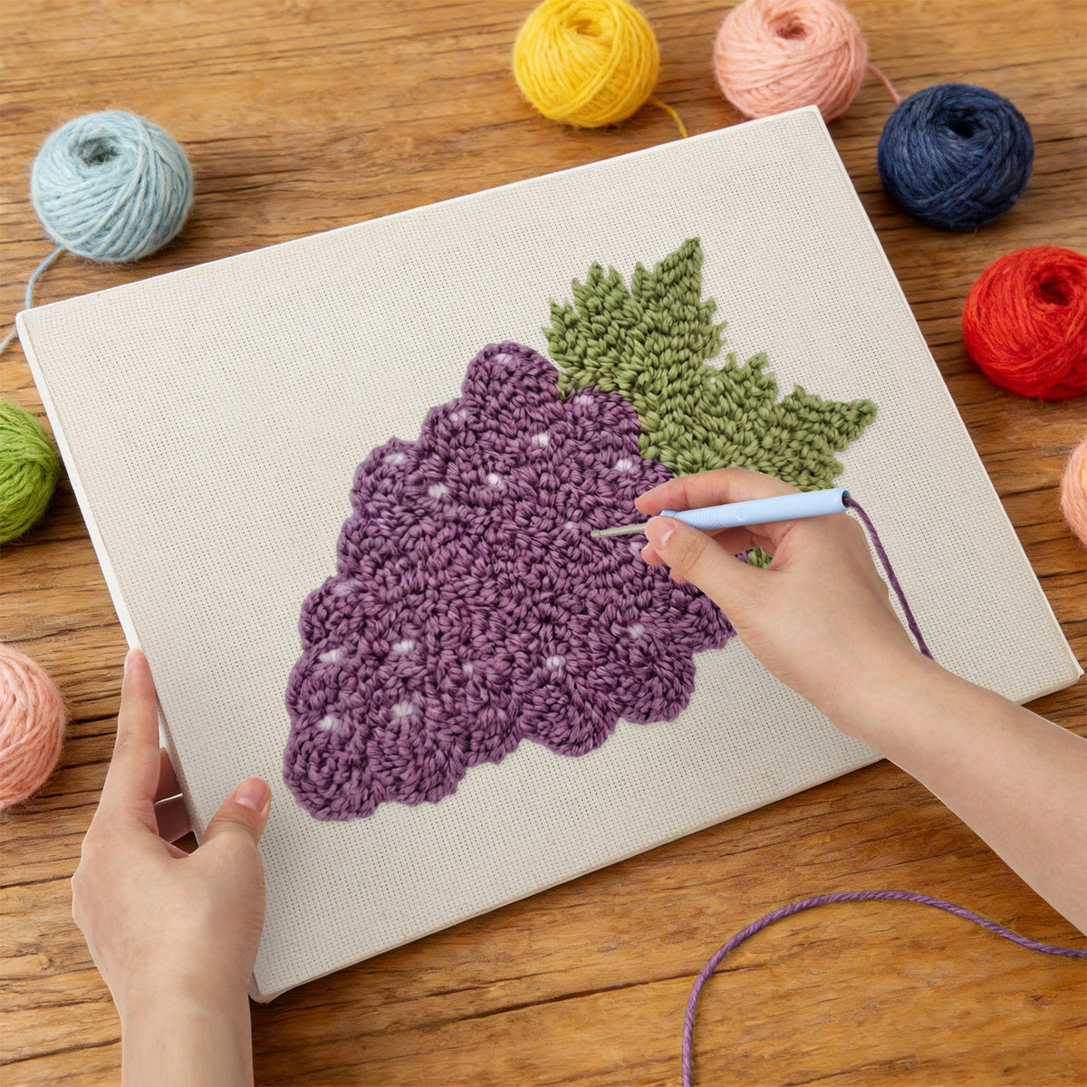 Punching the Purple Grapes design with the punch needle