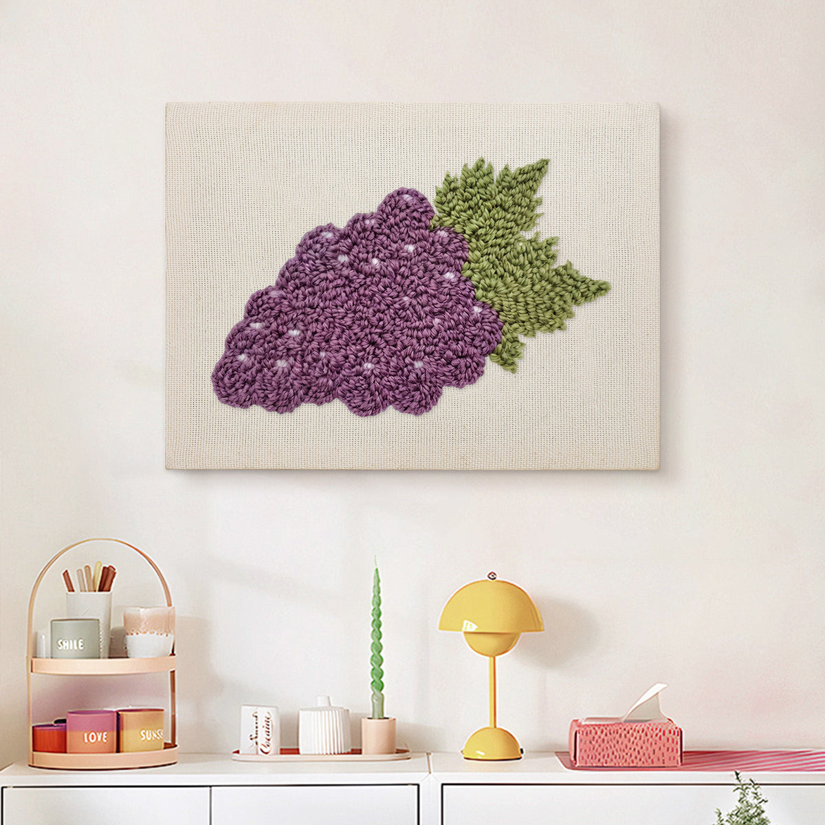 Finished Purple Grapes punch needle canvas on a wall
