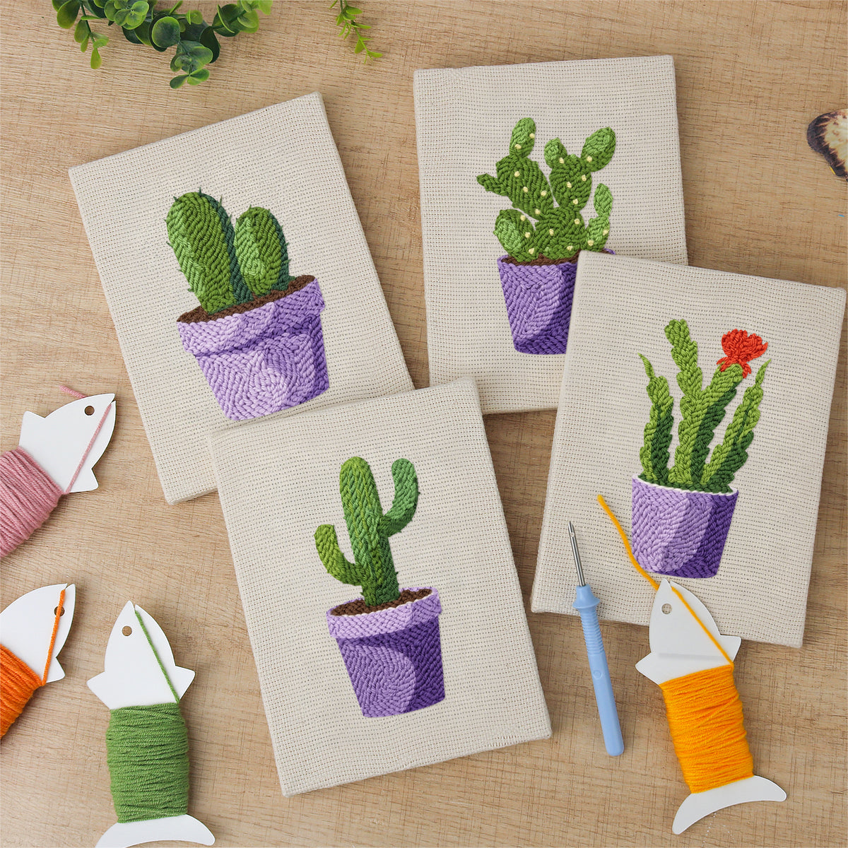 The four finished Purple Pot Cacti mini canvases laid out on a table