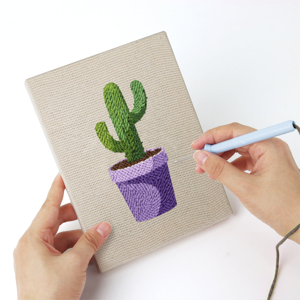 Punching a Purple Pot Cacti mini canvas with the punch needle