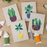 The four finished Purple Pot Plants mini canvases laid out on a table