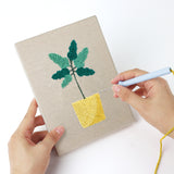 Punching a Purple Pot Plants mini canvas with the punch needle