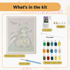 What is in the Raccoon Trick-or-Treater kit: printed canvas, punch needle, threader, threads, color guide and hangers