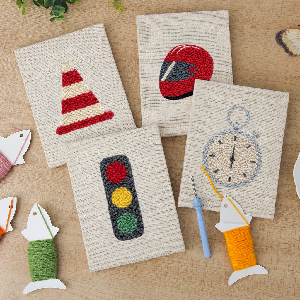 The four finished Race Day Gear mini canvases laid out on a table
