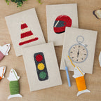 The four finished Race Day Gear mini canvases laid out on a table