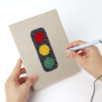 Punching a Race Day Gear mini canvas with the punch needle