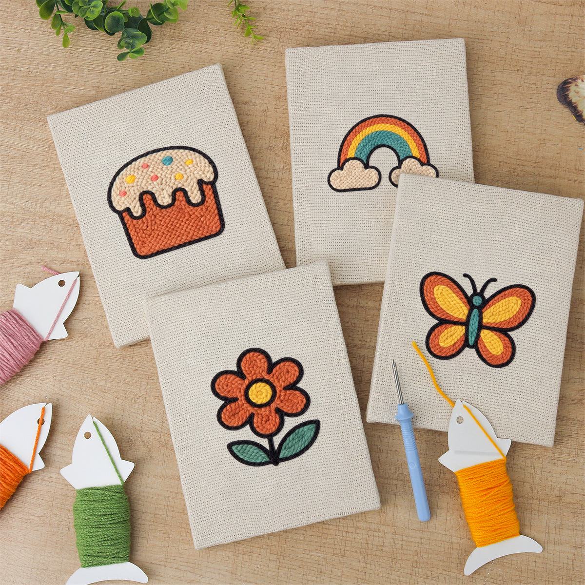 The four finished Rainbow and Butterfly mini canvases laid out on a table
