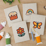 The four finished Rainbow and Butterfly mini canvases laid out on a table