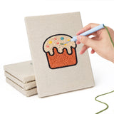 Hand punching one of the Rainbow and Butterfly mini canvases