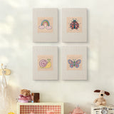 The four Rainbow and Ladybug mini canvases on a wall above a shelf