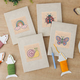 The four finished Rainbow and Ladybug mini canvases laid out on a table