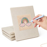 Hand punching one of the Rainbow and Ladybug mini canvases