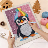 Punching the Rainbow Beanie Penguin design with the punch needle