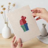 Hand holding a finished Rainbow Pot Cacti mini canvas
