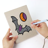 Punching a Reaper and Bat mini canvas with the punch needle