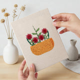 Hand holding a finished Red Bloom Bowls mini canvas