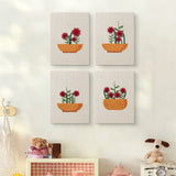 The four Red Bloom Bowls mini canvases on a wall above a shelf