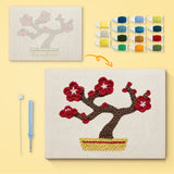 Red Blossom Bonsai canvas before and after punching, with the threads and tools