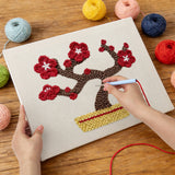 Punching the Red Blossom Bonsai design with the punch needle