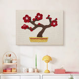 Finished Red Blossom Bonsai punch needle canvas on a wall