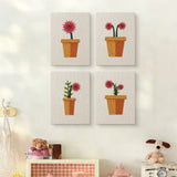 The four Red Daisy Pots mini canvases on a wall above a shelf
