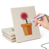 Hand punching one of the Red Daisy Pots mini canvases