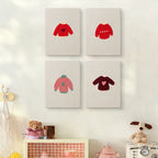 The four Red Heart Sweaters mini canvases on a wall above a shelf