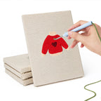 Hand punching one of the Red Heart Sweaters mini canvases