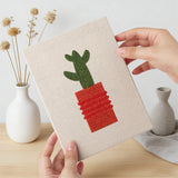 Hand holding a finished Red Pot Cacti mini canvas