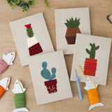 The four finished Red Pot Cacti mini canvases laid out on a table