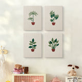 The four Red Pot Palms mini canvases on a wall above a shelf