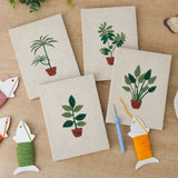 The four finished Red Pot Palms mini canvases laid out on a table