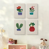 The four Red Pot Posies mini canvases on a wall above a shelf