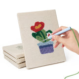 Hand punching one of the Red Pot Posies mini canvases