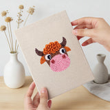 Hand holding a finished Reindeer and Cow mini canvas