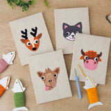 The four finished Reindeer and Cow mini canvases laid out on a table