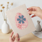 Hand holding a finished Retro Flower Eggs mini canvas