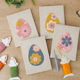 The four finished Retro Flower Eggs mini canvases laid out on a table