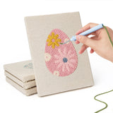 Hand punching one of the Retro Flower Eggs mini canvases