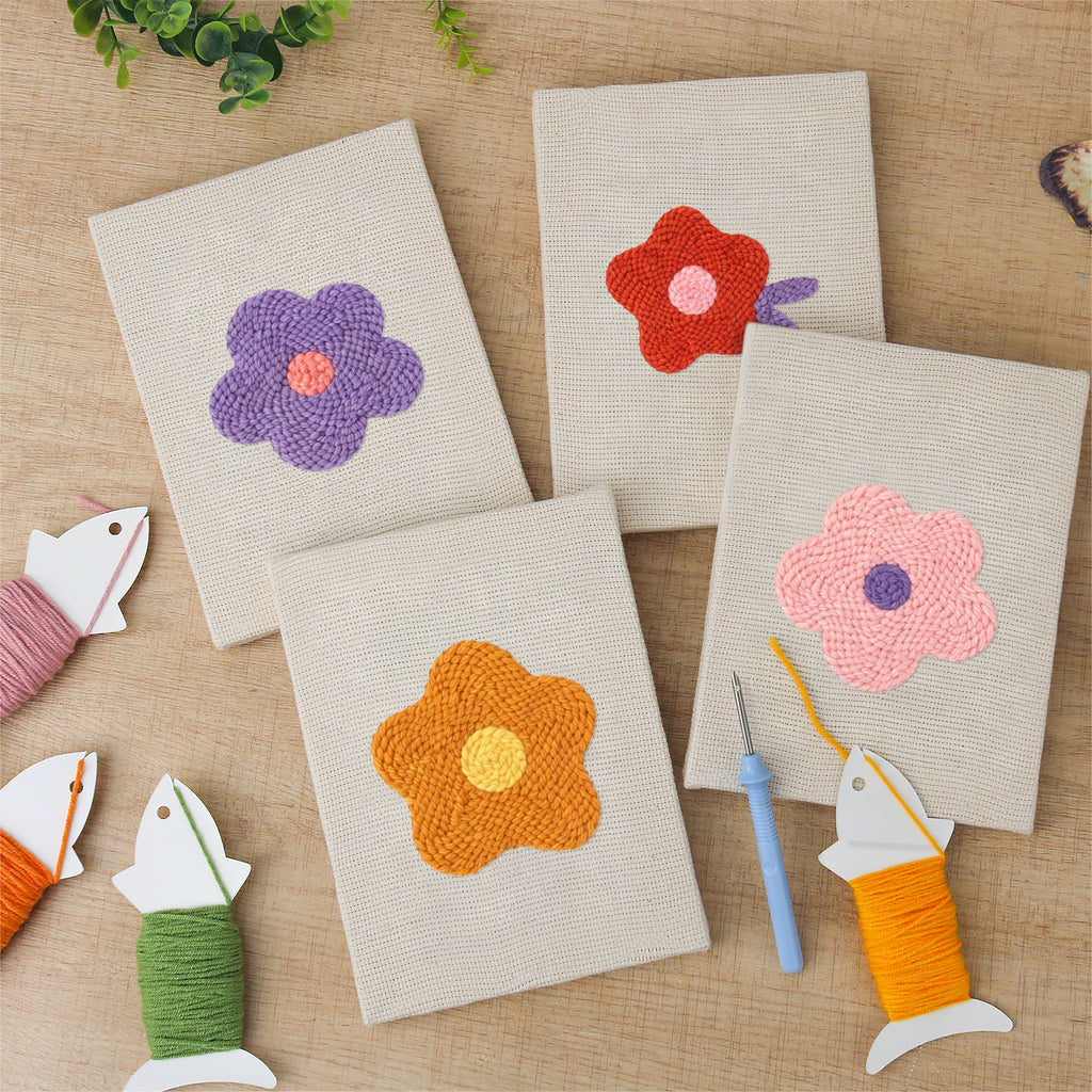 The four finished Retro Flower Heads mini canvases laid out on a table